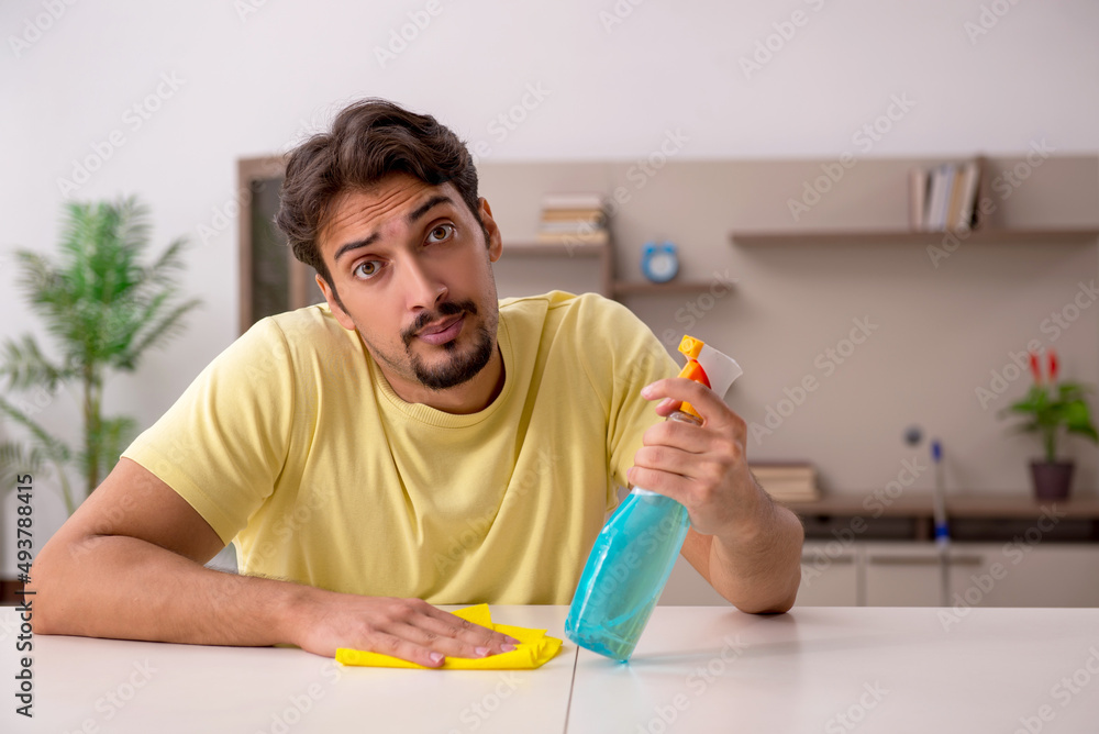 Young man doing housework at home Young man doing housework at home