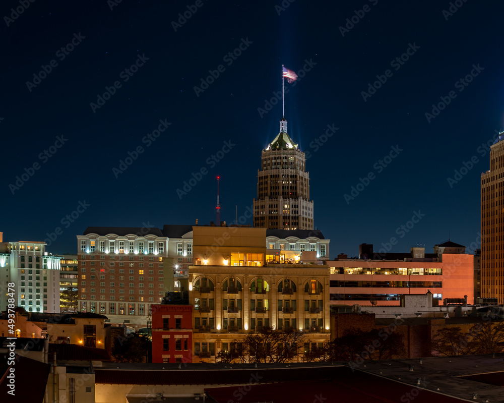 View of American Flag Lit Up on Top of Buiding in Downtown San Antonio, TExas