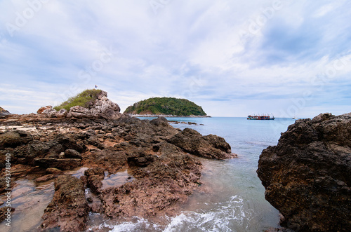 Beautiful landscape with sea, rock, stones and cloudy sky.