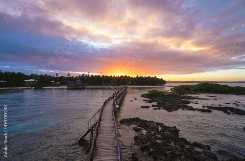 Beautiful landscape. Sunset on the seashore. Wooden bridge on Cloud Nine beach, Siargao Island Philippines.