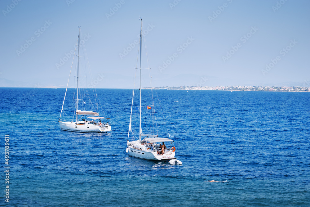 Beautiful landscape with yachts in blue lagoon.