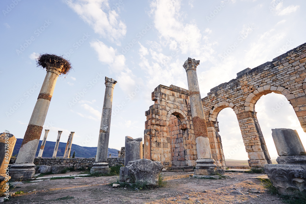 Beautiful sunset lanscape. The ruins of ancient antigue roman city Volubilis in Morocco, Africa. Beautiful sunset lanscape. The ruins of ancient antigue roman city Volubilis in Morocco, Africa.