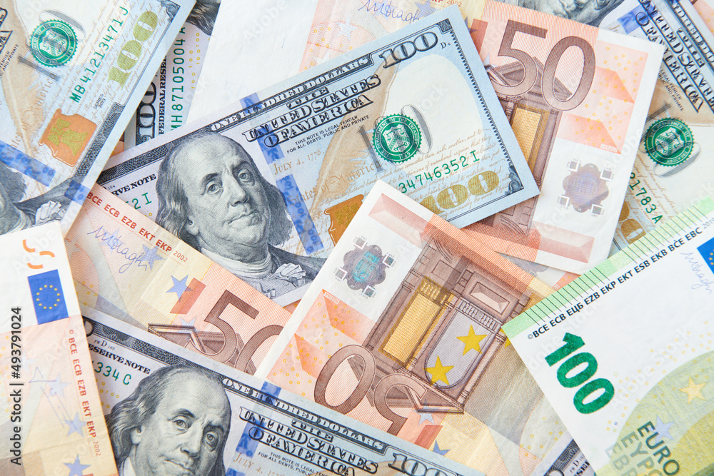 Dollars and Euros bills background. Currency background. Heap of american dollars and europe euro. Currency exchange concept. top view. Dollars and Euros bills background. Currency background. Heap of american dollars and europe euro. Currency exchange concept. top view.