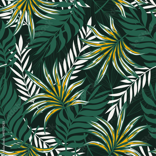Original seamless tropical pattern with bright plants and leaves on a dark green background. Vintage pattern. Tropic leaves in bright colors. Exotic wallpaper.