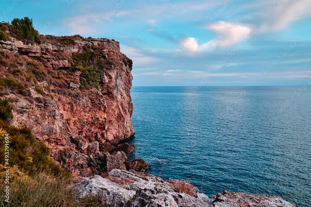 Sea cliffs and rocks on acoast. Beautiful sunset landscape.