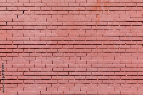 A brick wall painted with red paint, background texture 