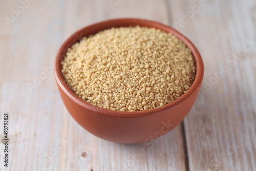 Dry couscous in a small ceramic bowl