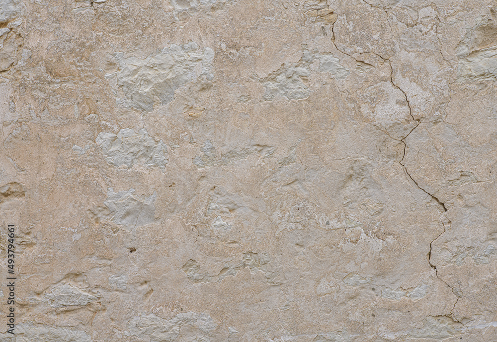Beige stone wall with cracks. Stone background. Beige stone wall with cracks. Stone background.