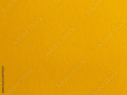 Felt yellow soft rough textile material background texture close up,poker table,tennis ball,table cloth. Empty yellow fabric background..