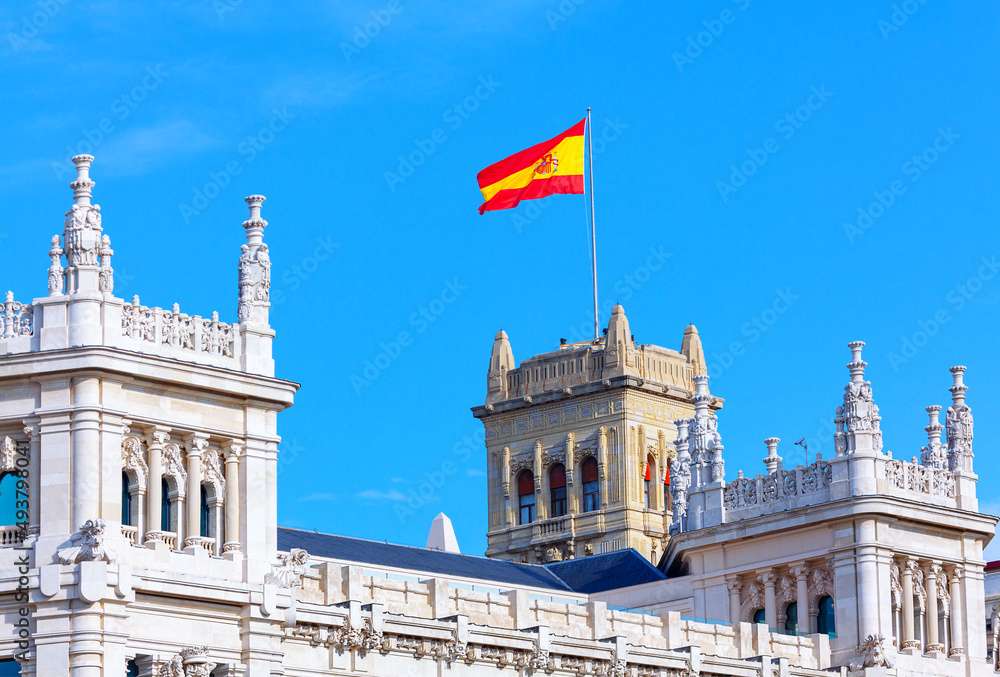 Spanish Flag on the Madrid City Hall . Waving flag of Spain on the architecture top 