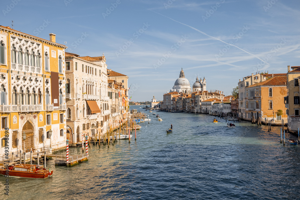 Beautiful view on Grand Canal from Accademia bridge with San Giorgio Maggiore church on the background in Venice. Italian landmarks and traveling Italy concept. Cityscape in autumn sunny day