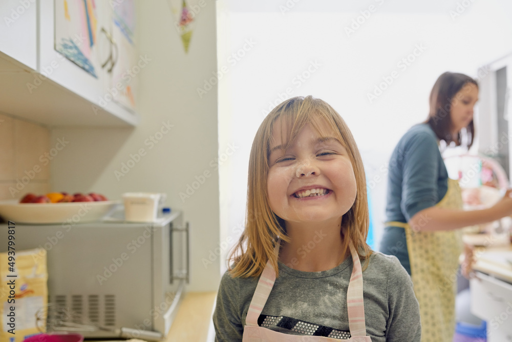 Have I got something on my nose. Portrait of a little girl standing in the kitchen with her face covered in flour. Have I got something on my nose. Portrait of a little girl standing in the kitchen with her face covered in flour.
