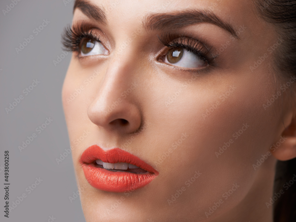 Natural beauty with a lipstick touch. Studio shot of an attractive young woman wearing colorful makeup. Natural beauty with a lipstick touch. Studio shot of an attractive young woman wearing colorful makeup.