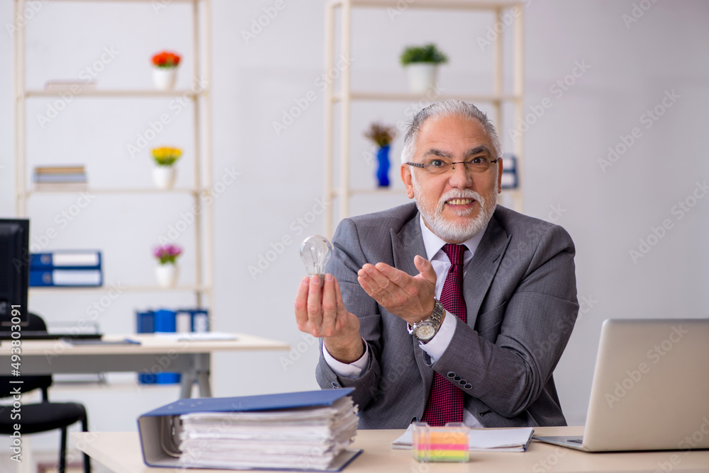 Old male employee in happy idea concept Old male employee in happy idea concept