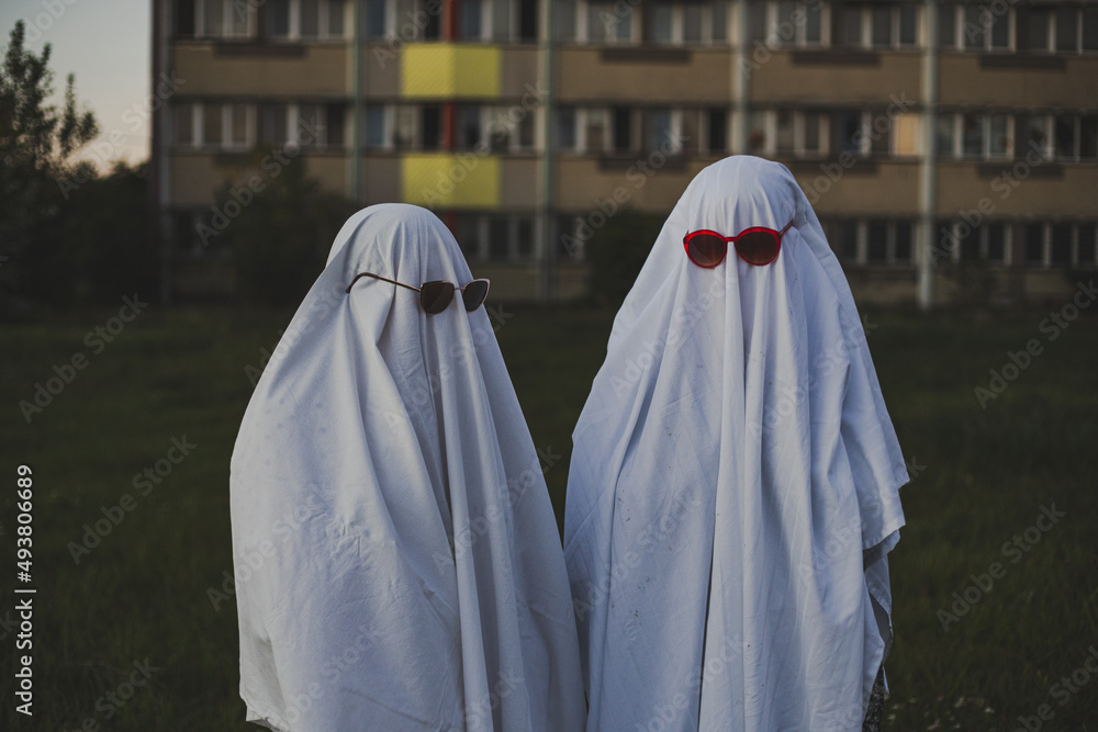 two people dressed up like funny ghosts in sunglasses