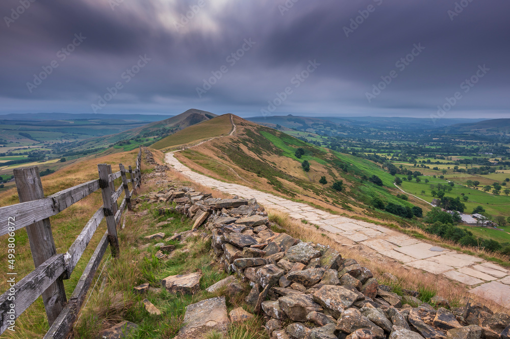 Mam Tor ridgeway, the Peak District, on a moody, cloudy summer's morning. Long exposure to show the movement in the clouds