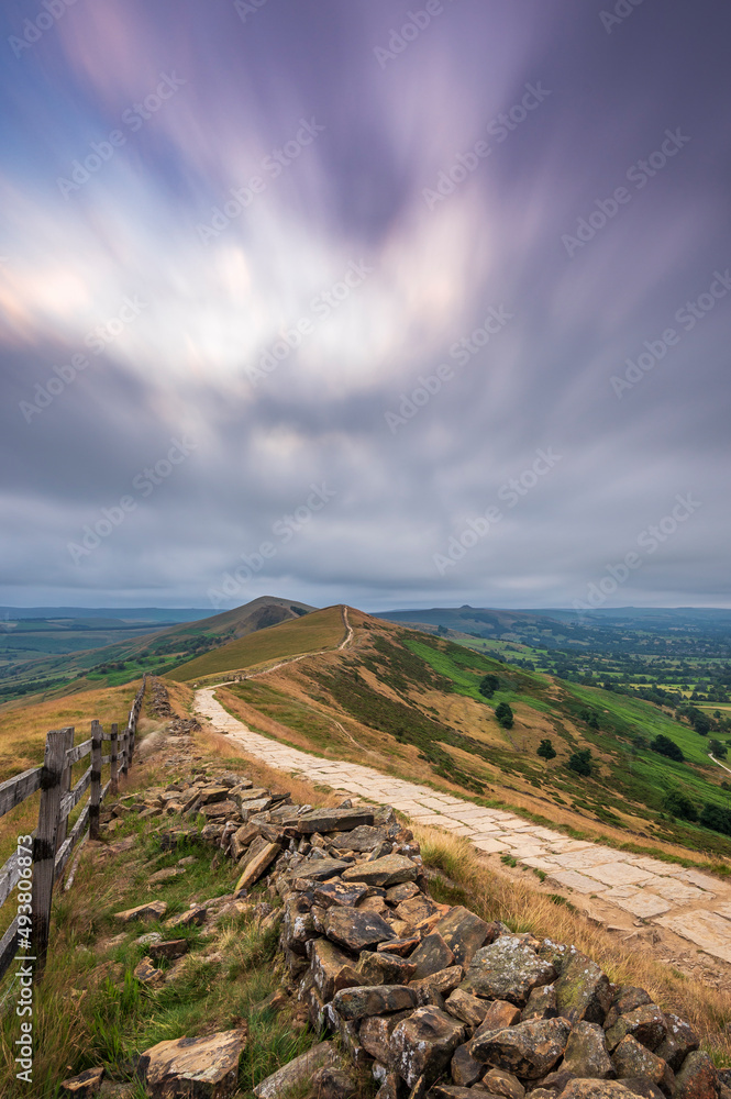 Mam Tor ridgeway, the Peak District, on a moody, cloudy summer's morning. Long exposure to show the movement in the clouds