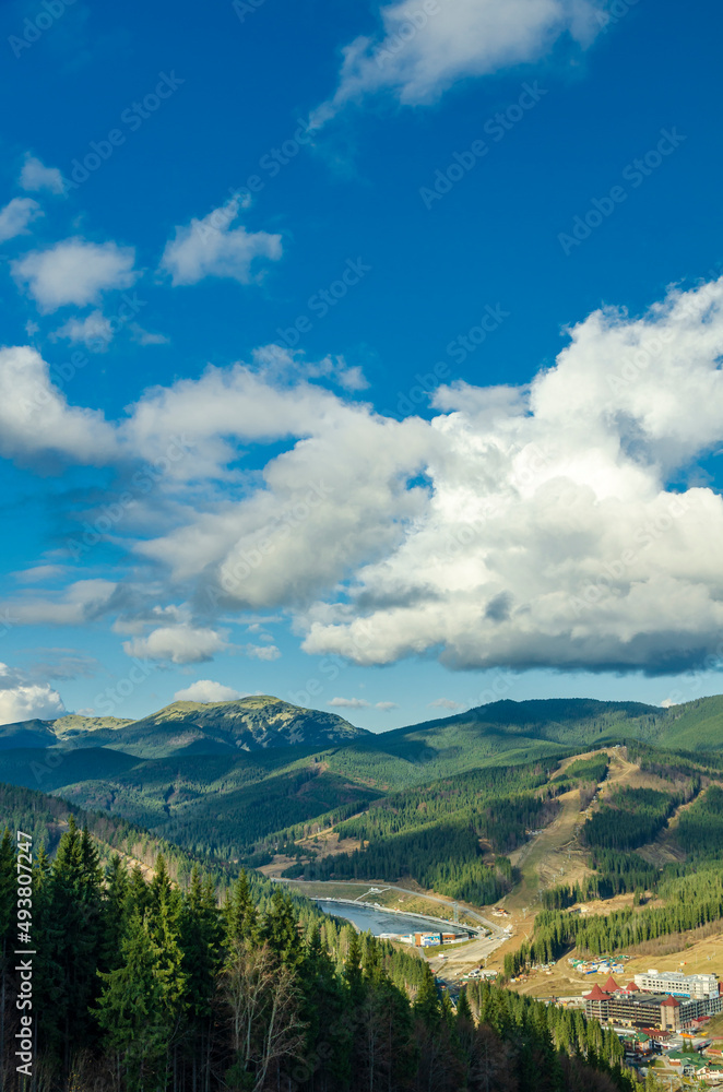 Magnificent panoramic view the coniferous forest on the mighty Carpathians Mountains and beautiful blue sky background. Beauty of wild virgin Ukrainian nature. Peacefulness. Magnificent panoramic view the coniferous forest on the mighty Carpathians Mountains and beautiful blue sky background. Beauty of wild virgin Ukrainian nature. Peacefulness.