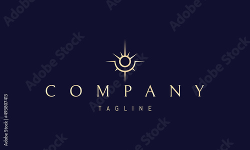 Vector golden logo on which an abstract image of a shining sun in the form of an eye.