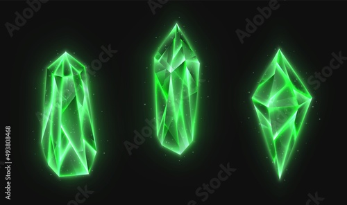 Realistic crystals set, green glowing gems collection isolated on a dark background. 3d magic stones with detailed texture.