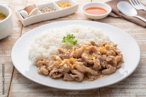 Stir-Fried Pork with Garlic and and pepper with cooked thai jasmine rice in white plate,popular Thai Street food