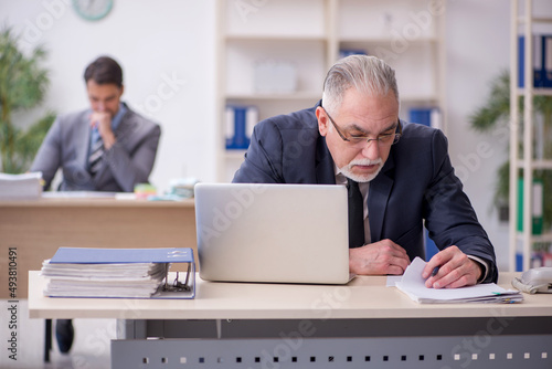 Two male employees working in the office