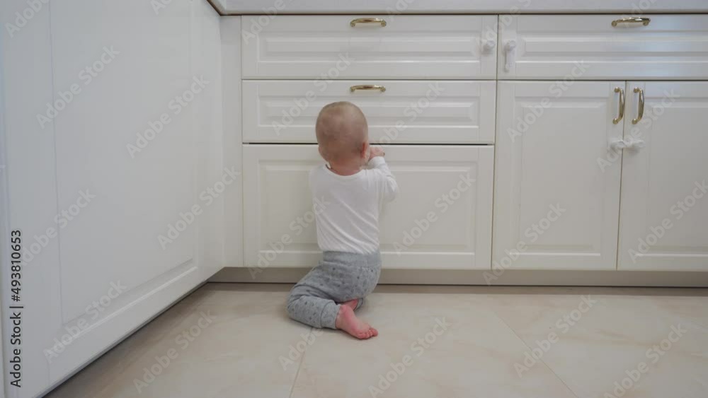 1 year old baby boy crawling on the floor in the living room, toddler exploring home curious infant walking through house. High quality 4k footage 1 year old baby boy crawling on the floor in the living room, toddler exploring home curious infant walking through house. High quality 4k footage