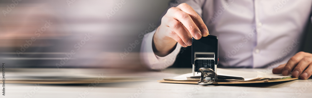 the man puts a seal on the document the man puts a seal on the document