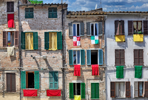  Fachadas de edificios en Gualdo Cattaneo (Italia) engalanados con banderas antes de un partido de football. photo