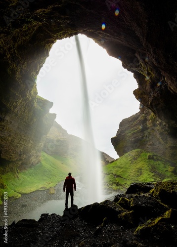 person in front of the waterfall
