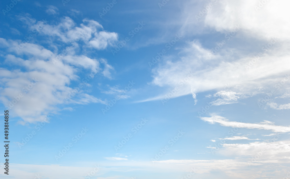 bright blue sky warm background with white clouds cumulus floating soft focus, copy space. bright blue sky warm background with white clouds cumulus floating soft focus, copy space.