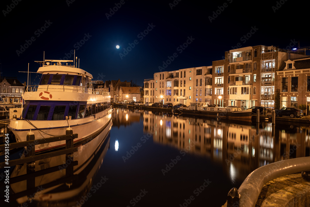 March 18, 2022, Zijlpoort Leiden, Netherlands, Image of the Oude Rijn Port Haven Leiden Town Historic City, and full moon