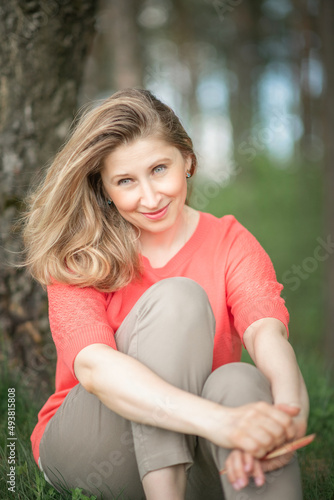 Portrait of a young beautiful fair-haired girl in a summer forest.