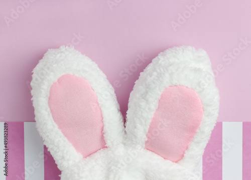 Bunny ears for Easter on pink background with copyspace