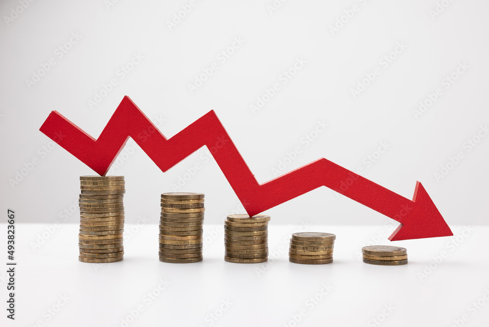 Red down arrow. Stack of gold coins, steps down. Money loss concept. Red down arrow. Stack of gold coins, steps down. Money loss concept.