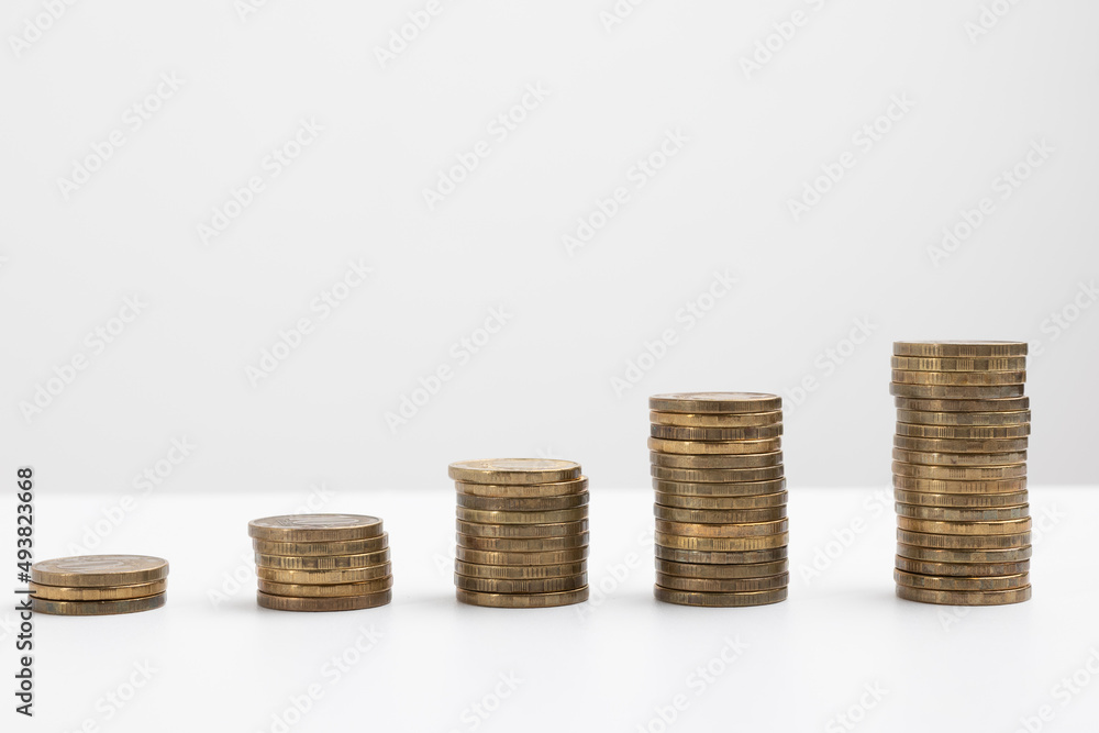coins stacked on a white background. Money saving concept coins stacked on a white background. Money saving concept