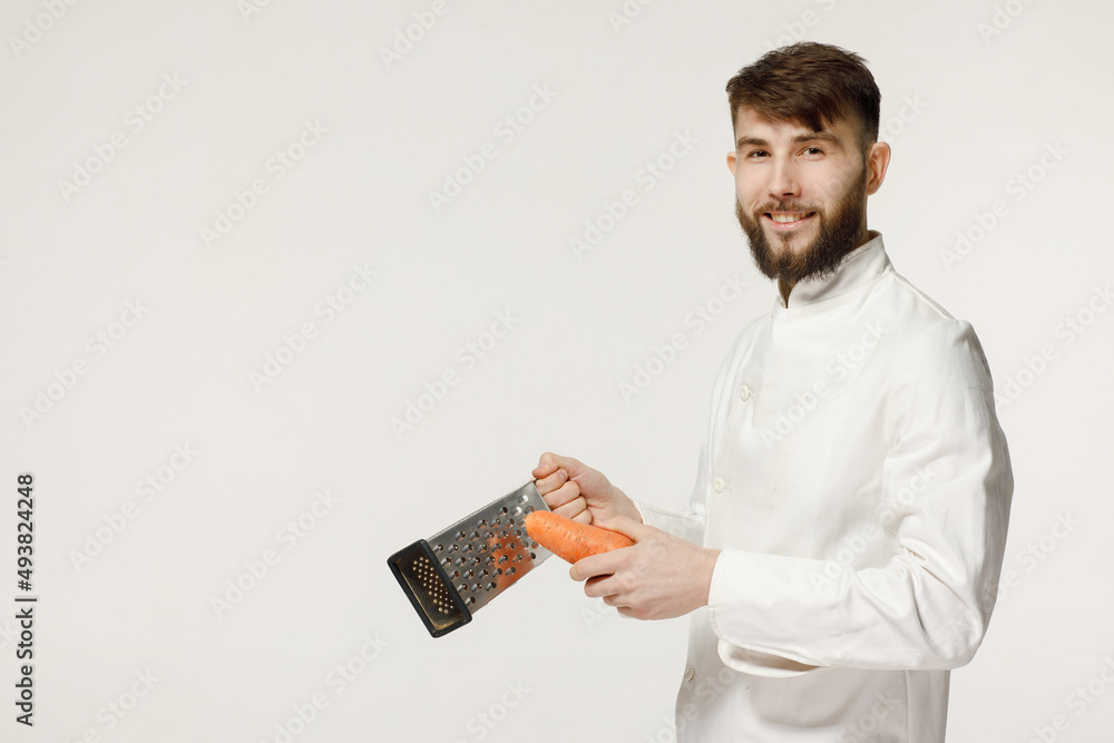 kind and handsome cook holds kitchen utensils on a white isolated background. concept for a cook kind and handsome cook holds kitchen utensils on a white isolated background. concept for a cook