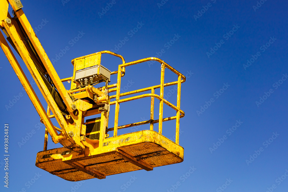 Basket lift, lifting platform on construction site. Basket lift, lifting platform on construction site.