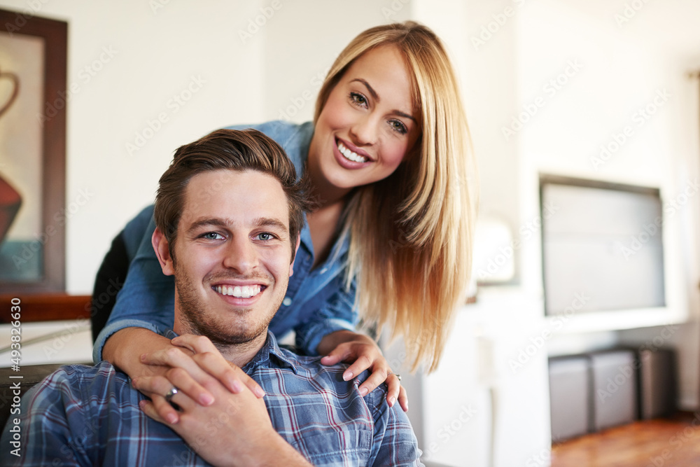 Our home is full of love. Cropped portrait of an affectionate young couple in their home.