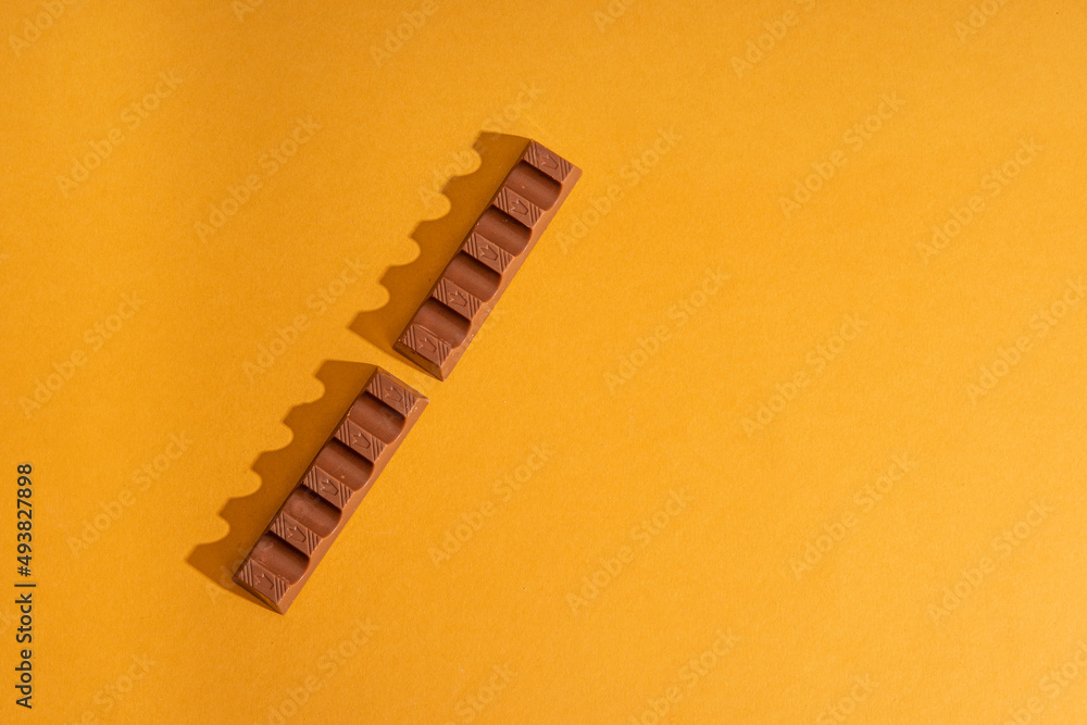 chocolate bar with milk filling on orange background chocolate bar with milk filling on orange background