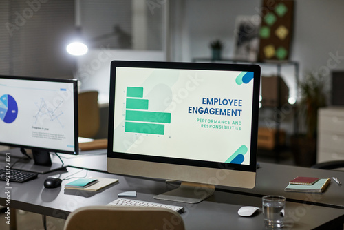 Background image of computer monitor in office with Employee engagement presentation, copy space