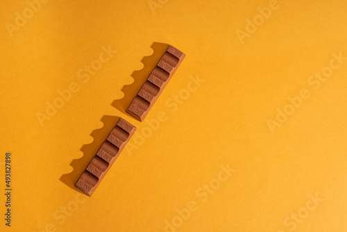 chocolate bar with milk filling on orange background