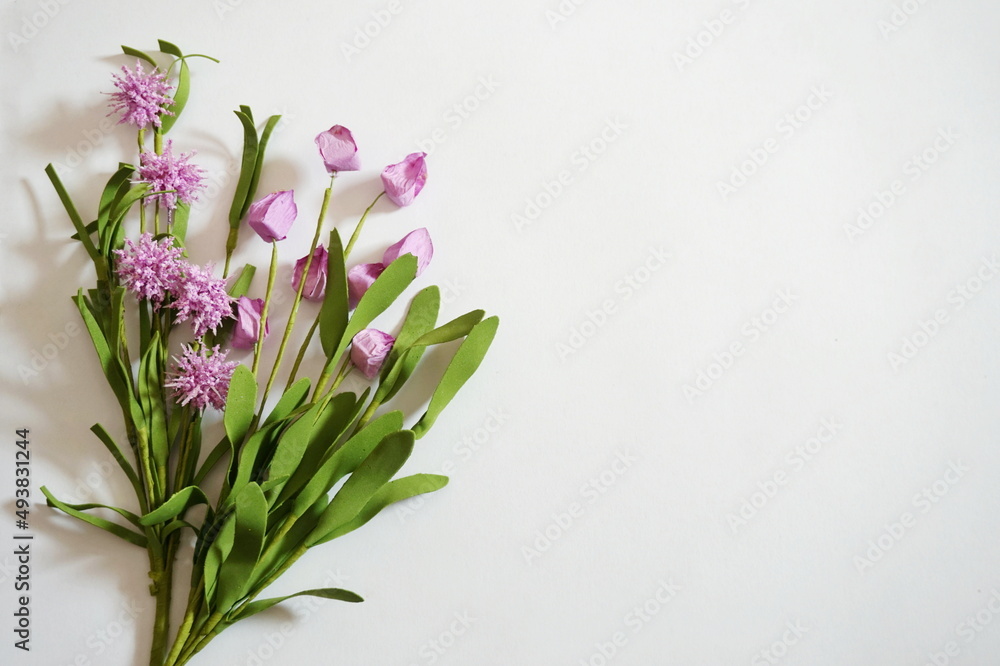 Lavender Posies and Green Leaves on Diagonal on Lower Right Corner of White Background Lavender Posies and Green Leaves on Diagonal on Lower Right Corner of White Background