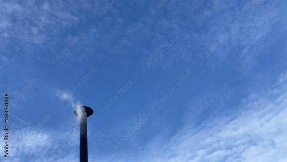 Smoke from house chimney on winter day against blue sky. Smoke from house chimney on winter day against blue sky.