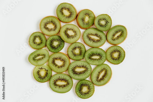 Fruity pattern of kiwi and slices on the white background.  Food concept. Flat lay, top view, copy space