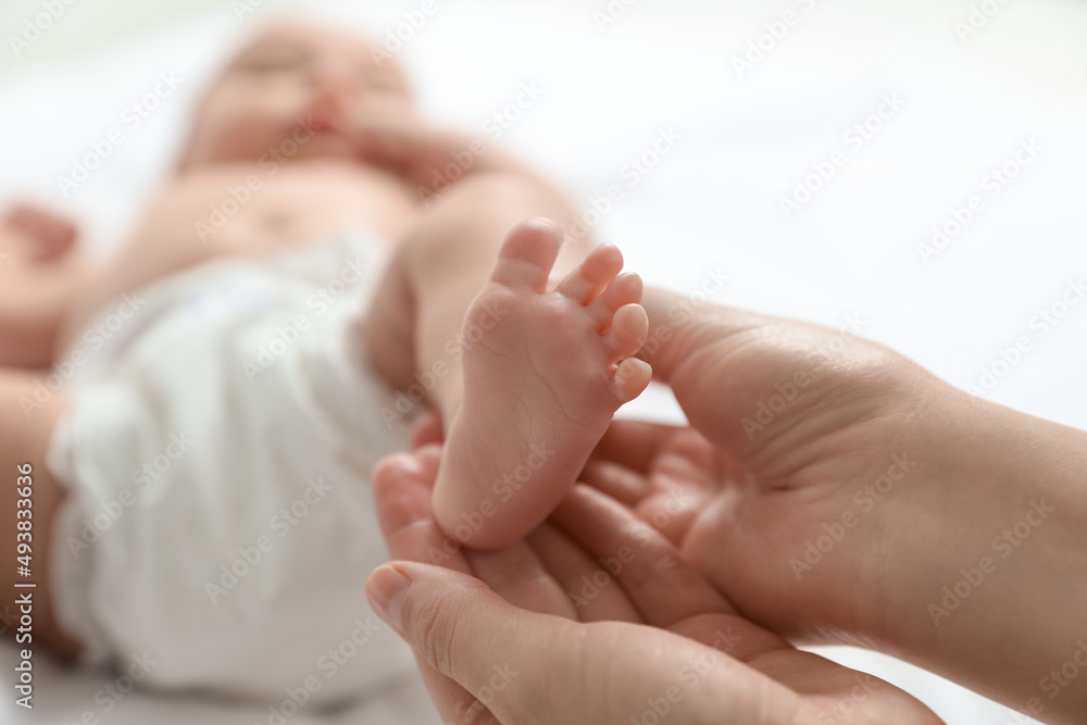 Mother massaging her cute baby with oil, closeup Mother massaging her cute baby with oil, closeup