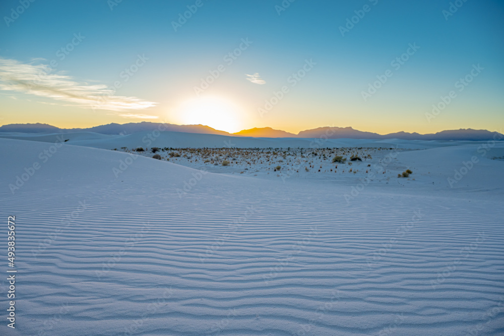 Brigth Yellow Sun Sets Behind San Andres Mountains And Blue Light Covers The Dunes