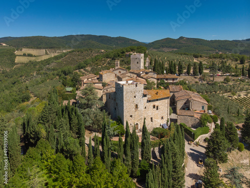 aerial view of old town in tuscany country - medieval castle - blue sky and green land
