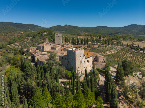 aerial view of old town in tuscany country - medieval castle - blue sky and green land