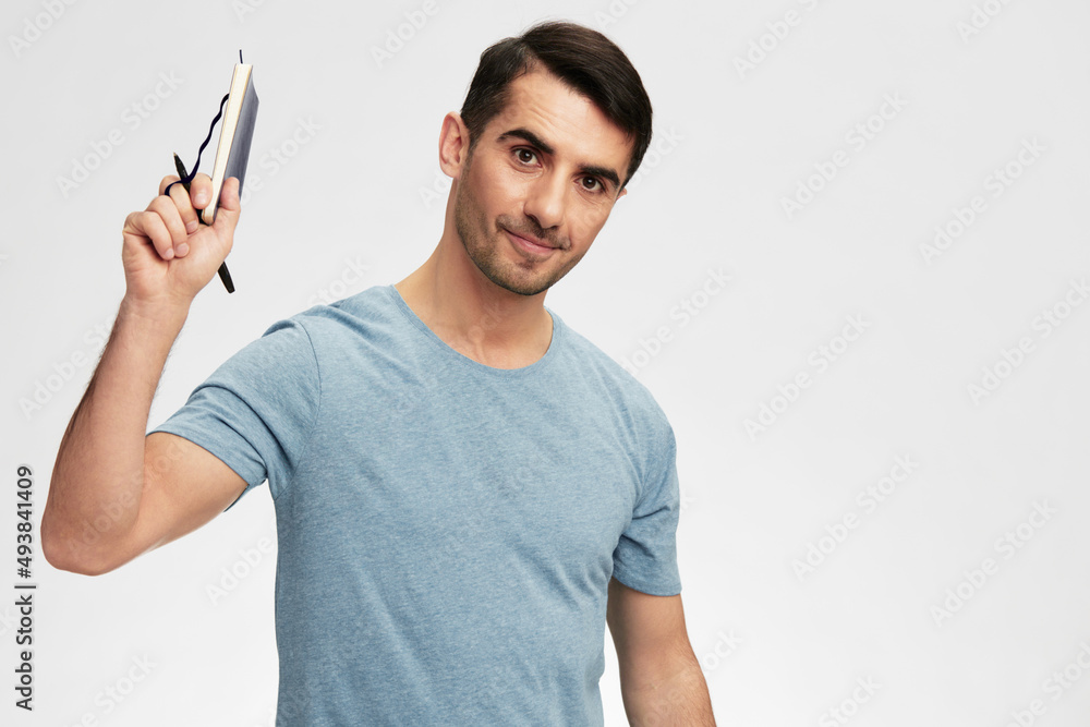 man writes in a notebook t-shirt glasses lifestyle isolated background man writes in a notebook t-shirt glasses lifestyle isolated background